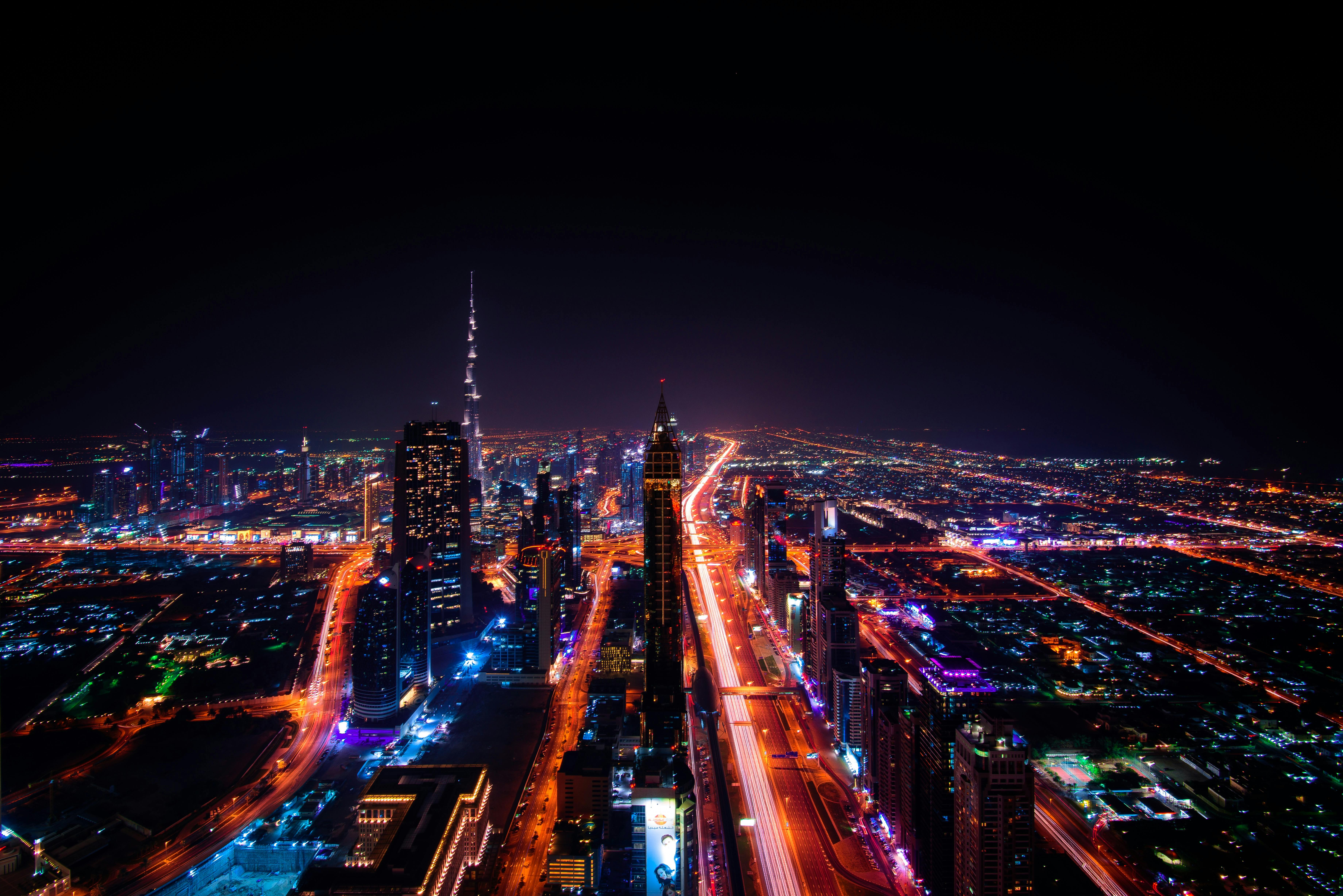 pexels-photo-219692-219692 A breathtaking aerial view of Dubai's cityscape at night, highlighting the illuminated Burj Khalifa and surrounding skyscrapers.
